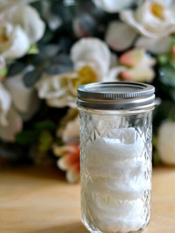 A close up of a mason jar filled with cotton face pads