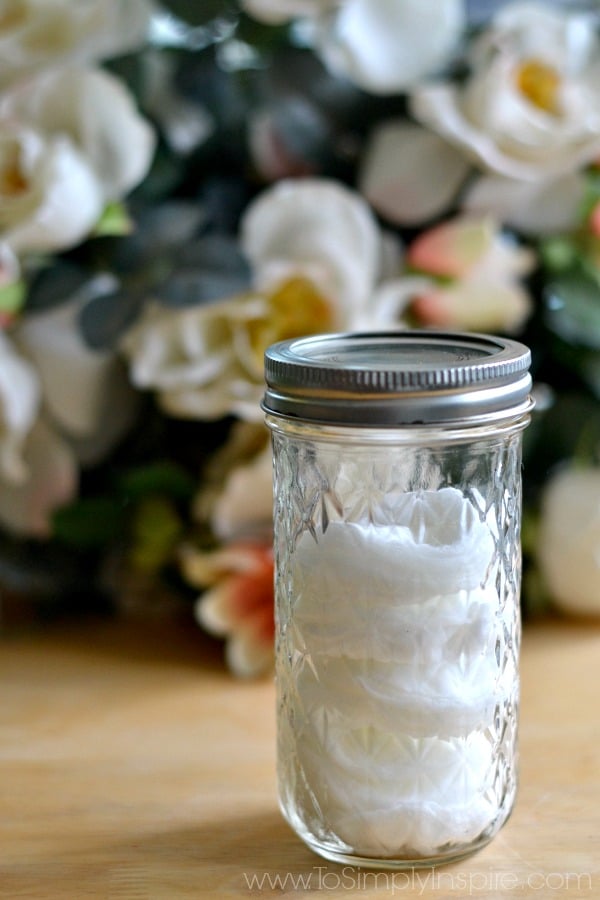 A close up of a mason jar filled with cotton face pads