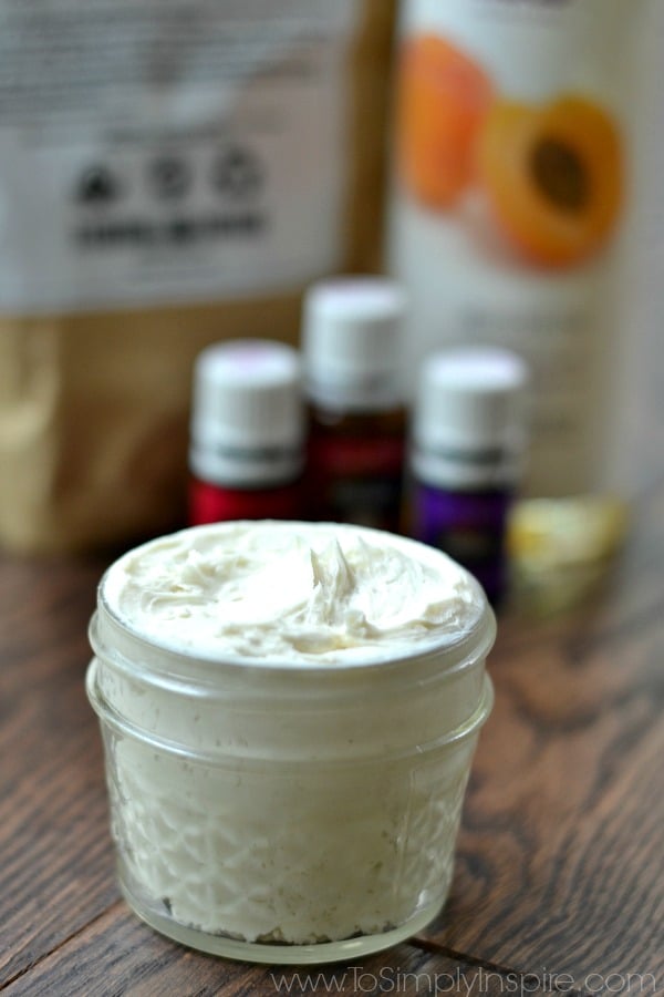 A close up of homemade lotion in a mason jar with essential oil and apricot oil 