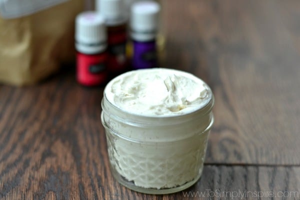 A close up of homemade lotion in a mason jar with essential oils