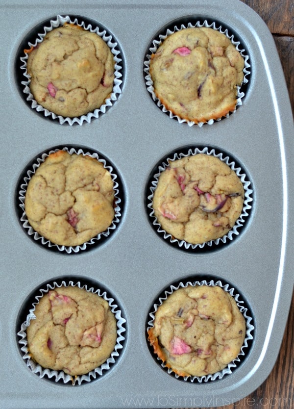 a muffin tin with banana rhubarb muffins