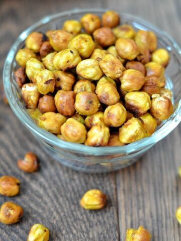 a glass bowl with roasted chickpeas