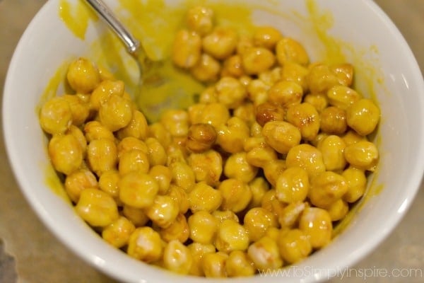 chickpeas in a white bowl mixed with mustard and honey