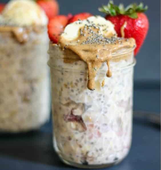 A close up of overnight oats with strawberries and peanut butter