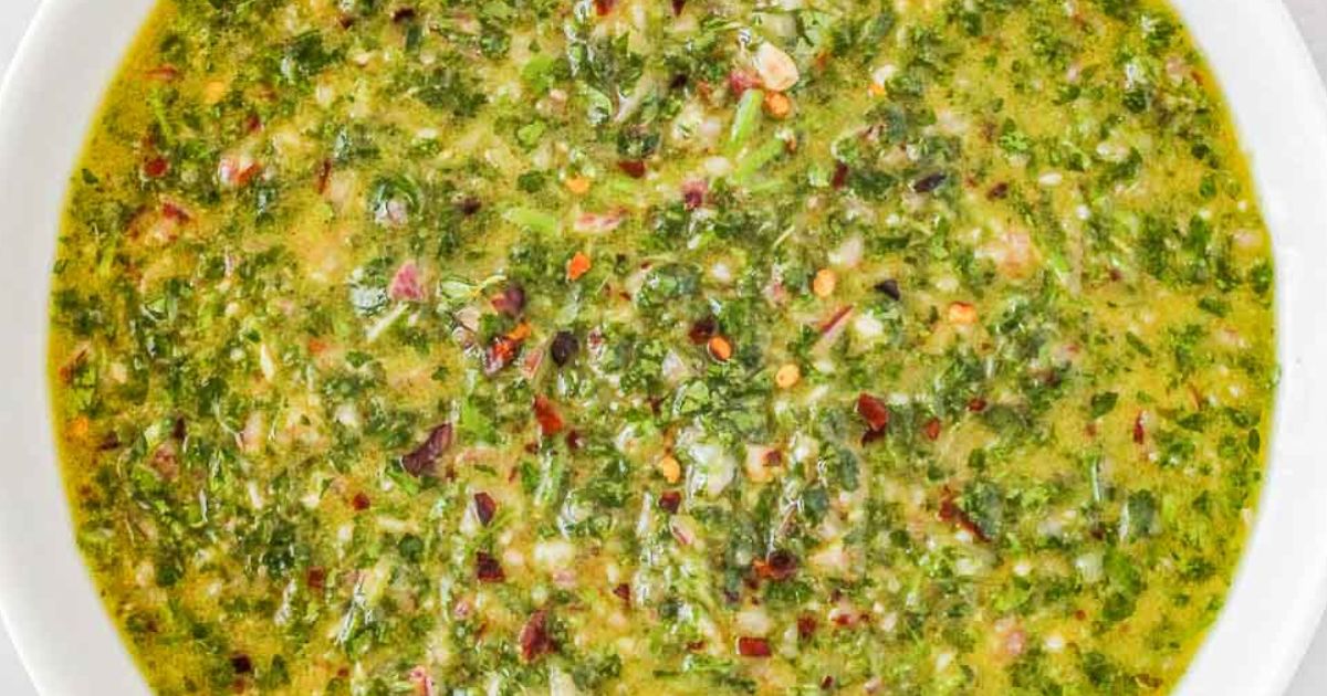 A bowl of Chimichurri Sauce with a spoon
