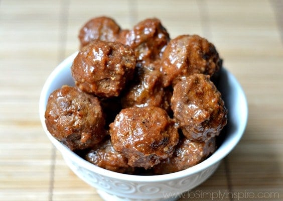 a white bowl filled with meatballs with a grape jelly ketchup sauce