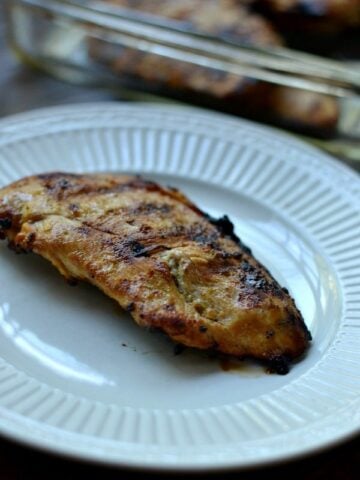closeup of grilled chicken on a white plate