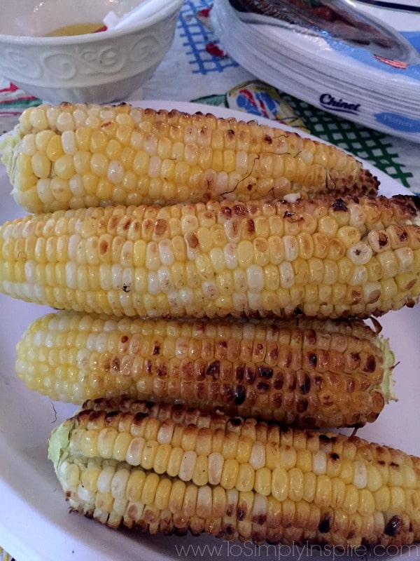 closeup of four ears of grilled corn on the cob