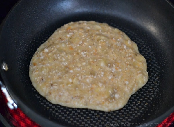 Banana Pancakes batter cooking in a black pan