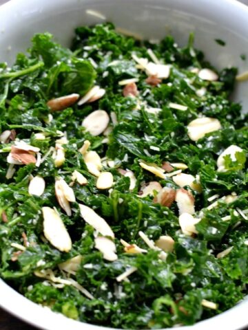 A bowl of salad with Kale and almond slices