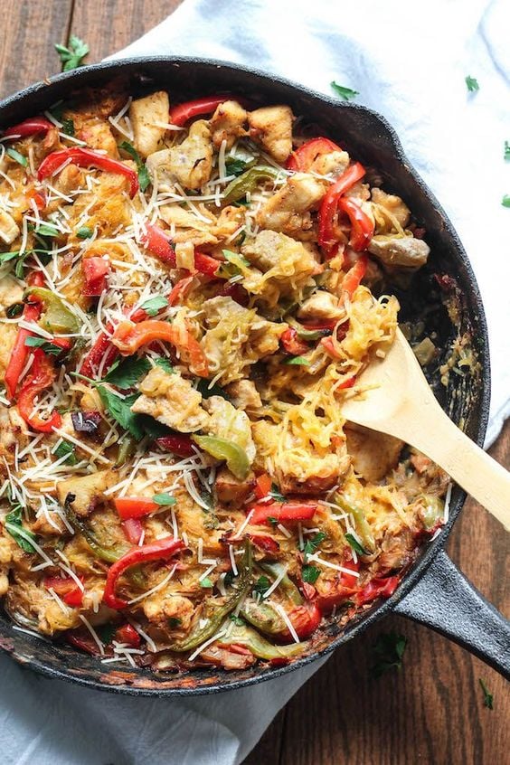 spaghetti squash with chicken and red peppers in a cast iron pan