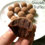 closeup of a Chocolate Truffle with a plateful in background