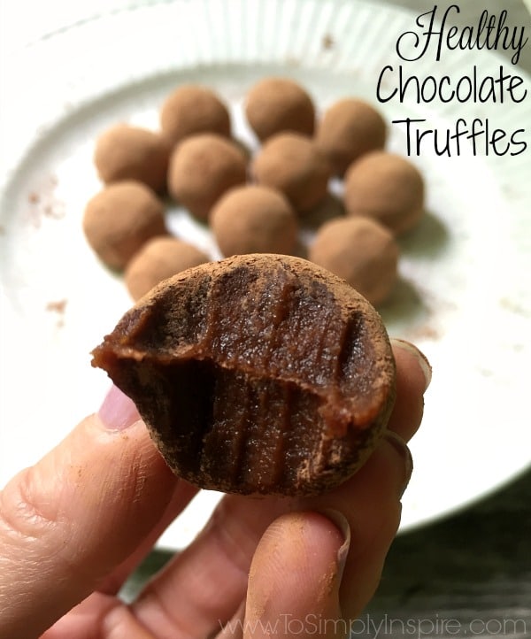 closeup of a chocolate truffle with a bite taken out