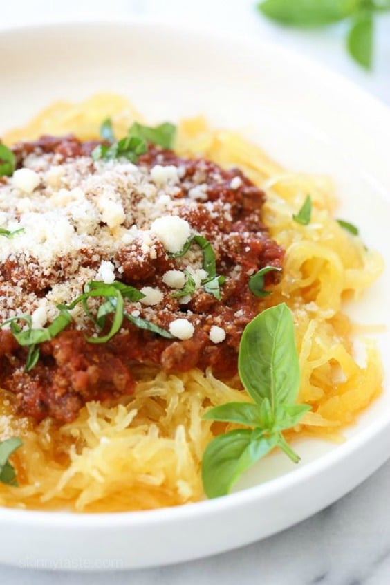 spaghetti squash on a white plate with spaghetti sauce