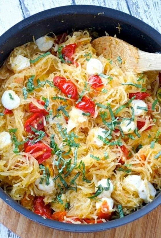 spaghetti squash with fresh mozzarella cheese chunks, tomatoes and fresh basil 