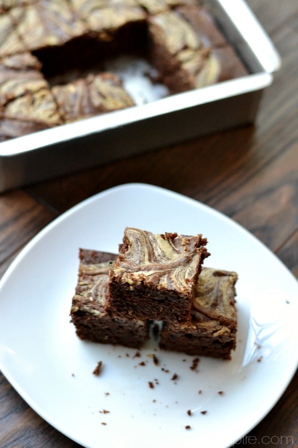 overhead of three brownies on a white plate