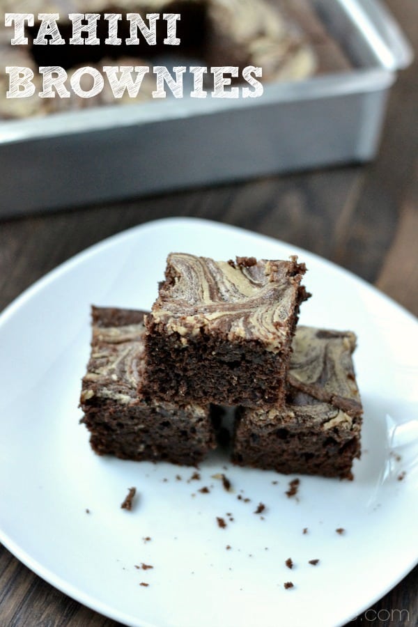 closeup of a stack of three brownies on a white plate
