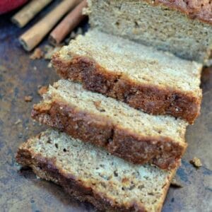 three slices of applesauce bread in front of the loaf of bread