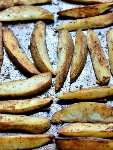 a baking sheet full of potato wedges