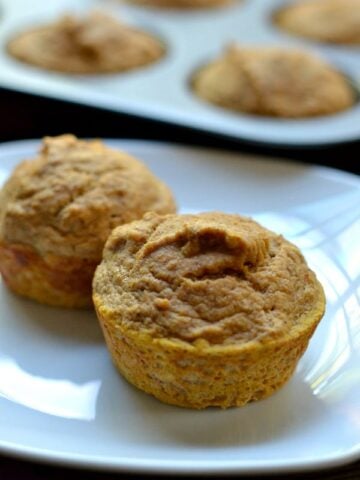close-up of two pumpkin muffins on a white plate