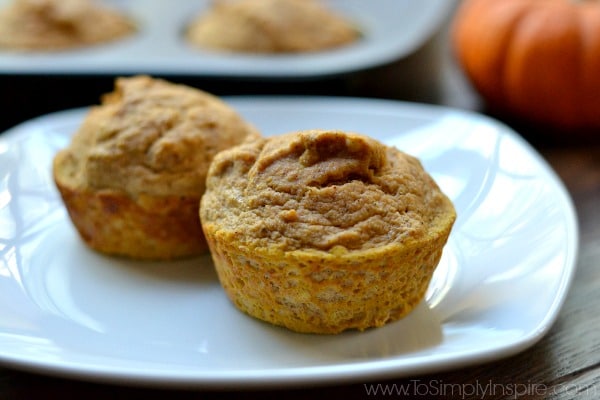 two pumpkin muffins on a white plate