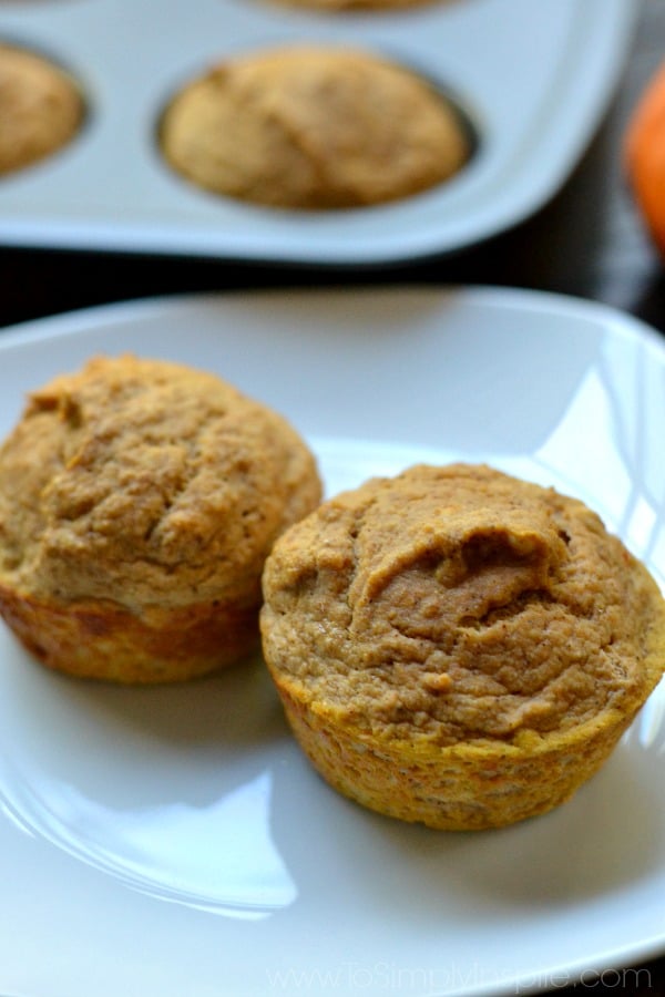 overhead closeup of two pumpkin muffins on a white plate