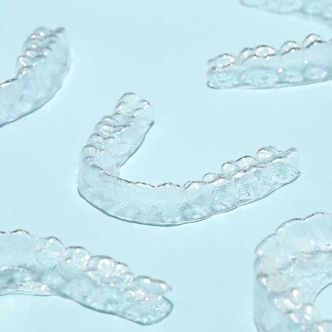 4 invisible aligners on a white background
