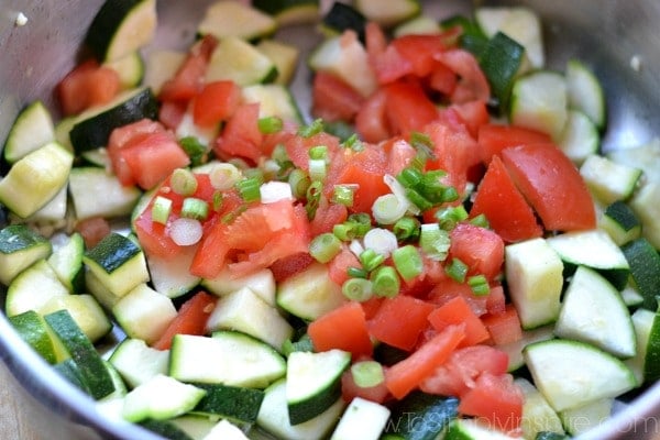 chopped tomatoes and zucchini in a pan