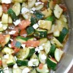 A bowl of diced zucchini with tomatoes and feta cheese