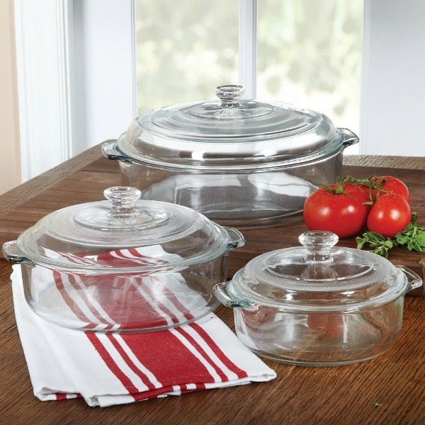 glass baking dishes with covers on a wood table
