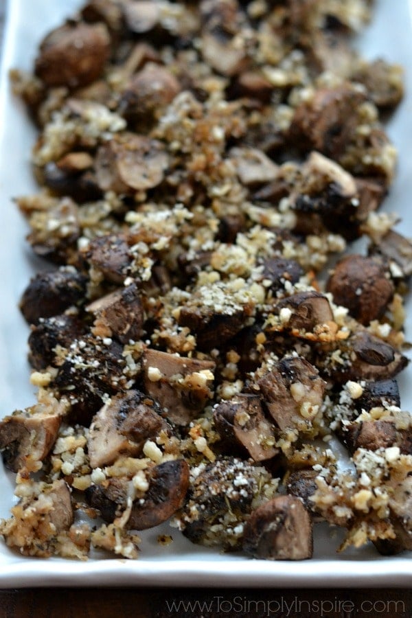 A closeup of a plate roasted mushrooms sprinkled with breadcrumbs