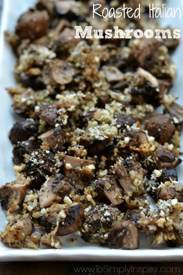 A closeup of a plate roasted mushrooms with breadcrumbs. 