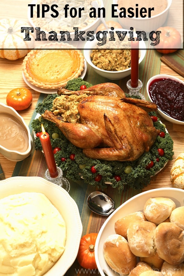 A thanksgiving turkey on a table surrounded by different side dishes