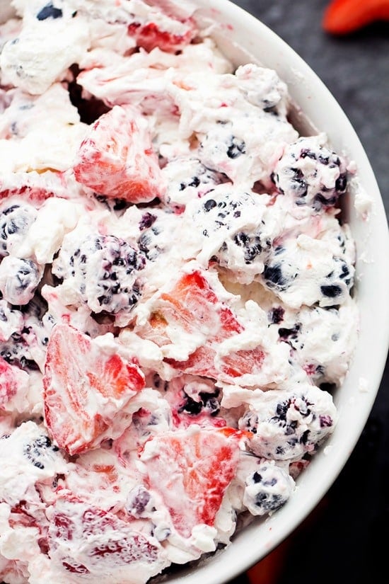 A close up of a Berry Cheesecake salad recipe in a white bowl