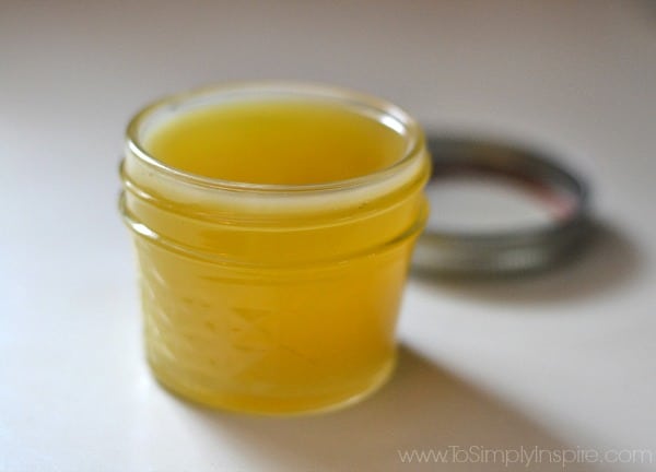 a small mason jar with yellow liquid