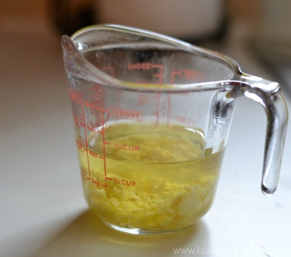 a glass measuring cup with yellow liquid