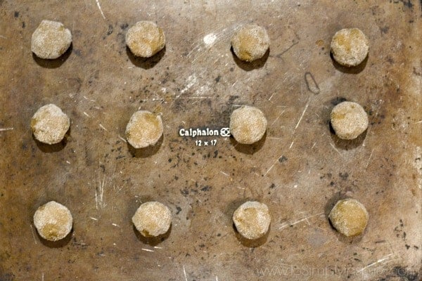 rolled up cookie dough balls on a baking sheet