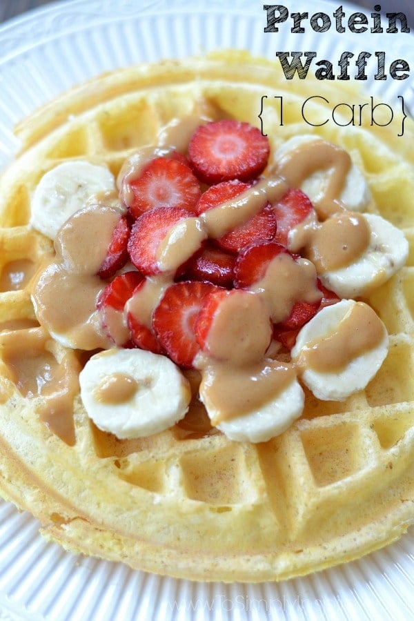 Closeup of Protein Waffle recipe topped with sliced strawberries and bananas drizzled with peanut butter.