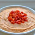 closeup of Roasted Red Pepper hummus recipe in a white bowl