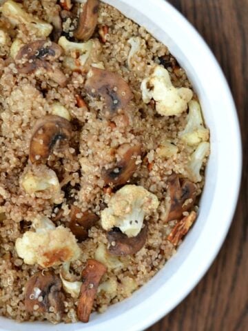 A bowl of quinoa, cauliflower and mushrooms in a white bowl