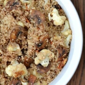 A bowl of quinoa, cauliflower and mushrooms in a white bowl