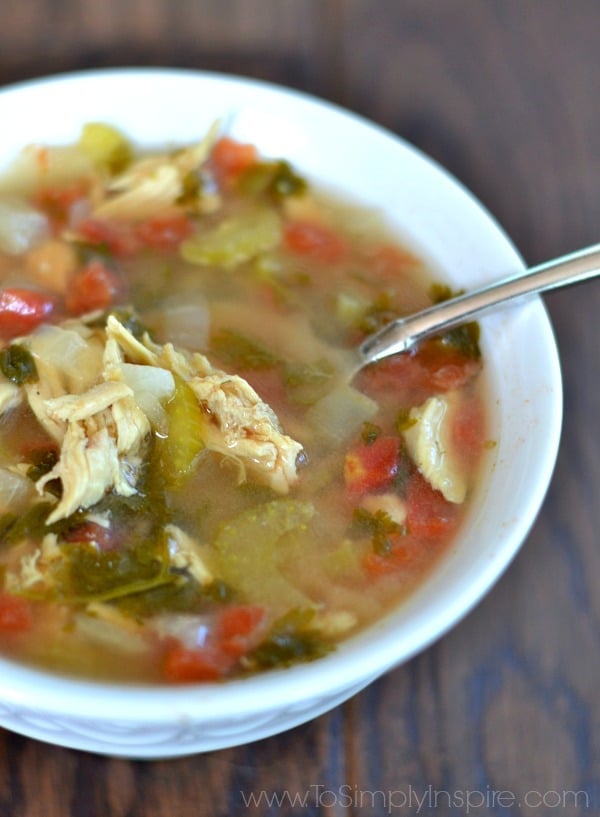 a closeup of Cilantro Lime Chicken Soup in a white bowl with a spoon