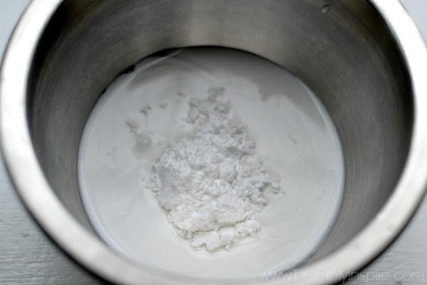 siiver mixing bowl with coconut milk and powder sugar 