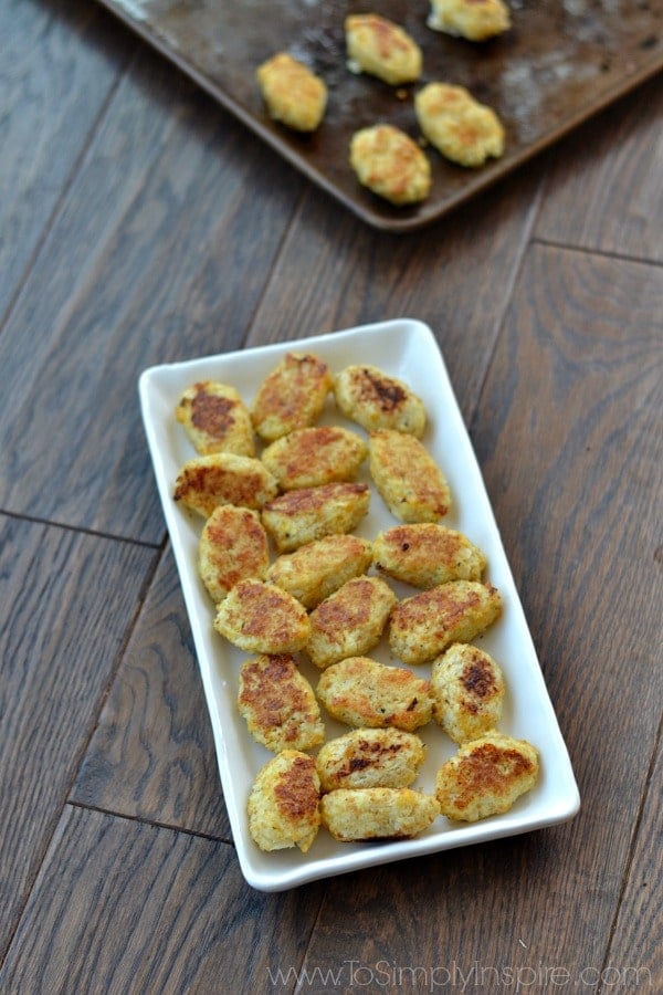 Cauliflower Tots recipe on a white plate on a wood table