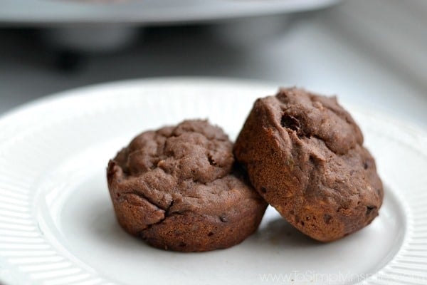 closeup of two chocolate muffins on a white plate