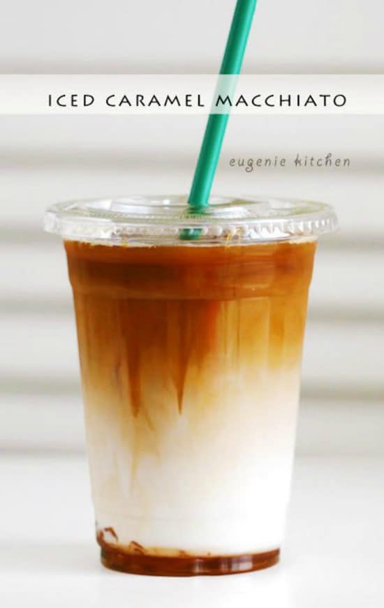 A close up of a iced caramel macchiato coffee with a green straw