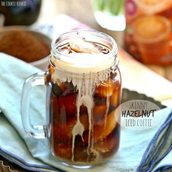 A glass much of iced coffee on a table with a light blue napkin