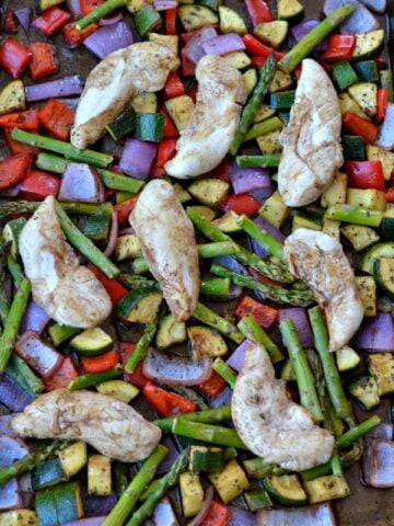 A close up of Chicken, red peppers, asparagus, onions
