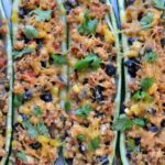 Closeup of Mexican Zucchini Boats with black beans and cilantro recipe in a casserole dish