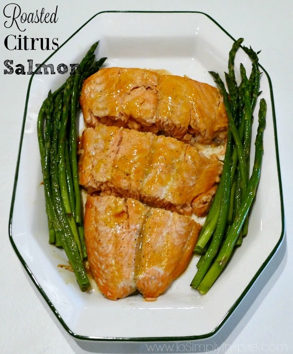 3 salmon slices and asparagus on the side on a white plate